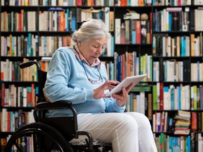 Wheelchair Bound Senior Woman Using a Digital Tablet-Researchers to use technology to better understand risk factors for Alzheimer's